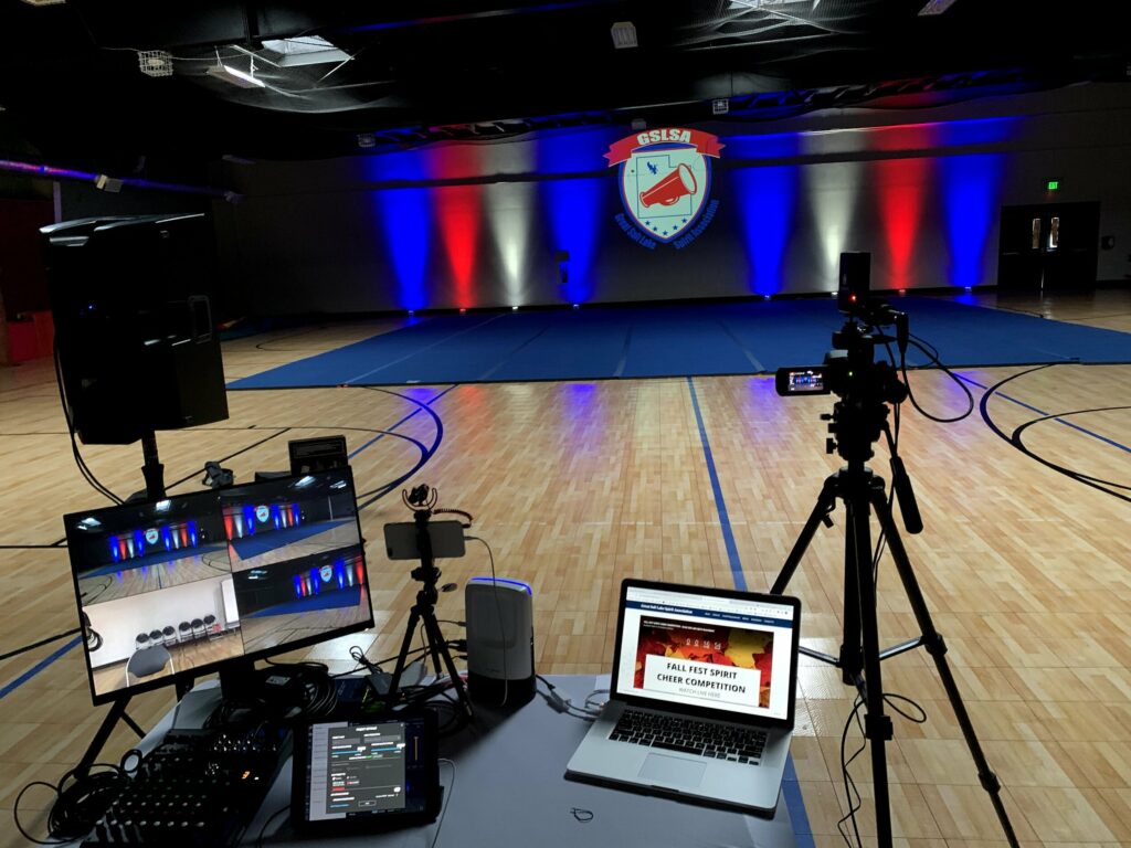 A live stream set up inside a gymnasium with lights and a competition dance floor.